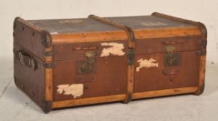 An early 20th Century travellers steamer trunk/ suitcase chest mound with wooden supports and