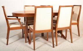 A 1970's good quality Stag teak wood extending dining table raised on splayed legs together with a