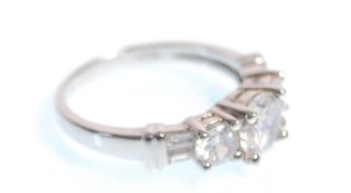 A stamped 925 silver ring set with three graduating round cut cz's . Weight 4.0g. Size P.5.