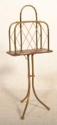 A late 19th / early 20th Century mahogany and brass magazine rack raised on a a brass tripod