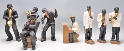 A collection of vintage ceramic figurines in the form of jazz players, complete with instruments, to