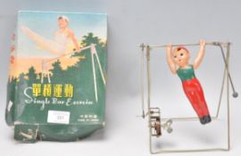 A vintage retro Chinese single bar exercise clock work toy, complete in its original box.