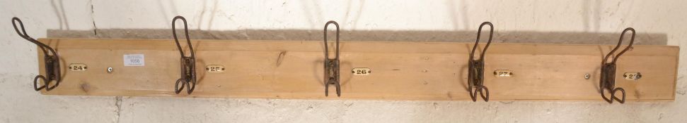 A set of early 20th Century vintage school / gymnasium hooks, five in total, each mounted on a