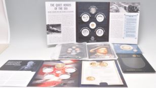 A mixed group of presentation coins to include a £20 pound coin made from genuine recovered