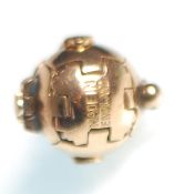 A hallmarked 9ct gold masonic ball pendant unfolding into six sections with geometric decoration and