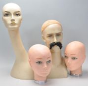 A collection of 20th century shop tailors - haberdashery dummy heads to include male and female.