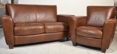 Natuzzi Italia - A contemporary brown leather two seater sofa settee and matching armchair. Both