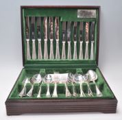 A 20th Century wooden cased Butler's cutlery canteen filled with silver plated cutlery, the interior