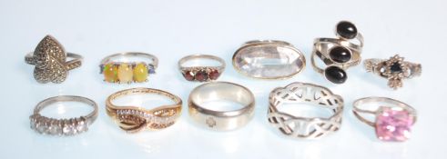 A group of eleven silver rings to include a heart design ring set with marcasites, a claddagh ring
