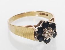 A hallmarked 9ct gold sapphire and diamond cluster