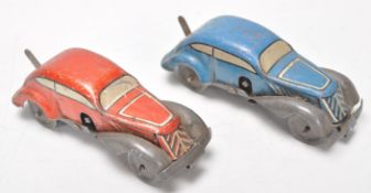 A pair of early 20th Century tinplate clockwork toy racing cars. One finished in red and the other
