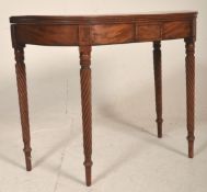 A 19th century George III mahogany card / games table being raised on spiral candy twist legs with