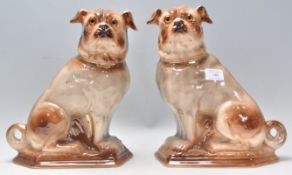 A pair of 19th Century Victorian ceramic pug type dogs moulded in a seated position with gilt