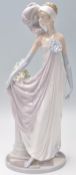 A Lladro porcelain figurine in the form of a 1920's flapper girl modelled with a feather headdress