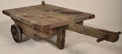 An early 20th century antique vintage industrial Bogie trolley having steel wheels with wooden