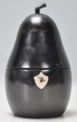 An antique style tea caddy in the form of a pear carved from ebonised wood having a shield scutcheon