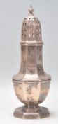 An early 20th Century silver hallmarked sugar caster shaker raised on stepped octagonal base with