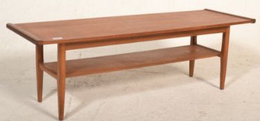 A good mid century Danish influence teak wood long john coffee table of rectangular form with