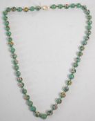 A vintage Chinese Cloisonne beaded necklace having round beads with a mint green ground with