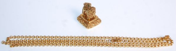 A gold plate Antique style intaglio seal fob having a lion figure raised upon a engraved floral seal