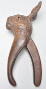 A good early 20th century black forest carved wooden pair of nut crackers in the form of a