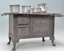 A vantage 20th Century miniature cast iron model of a Victorian stove / oven having a series of