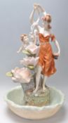 A vintage Italian resin Capodimonte style water feature in the form of a female figure amongst