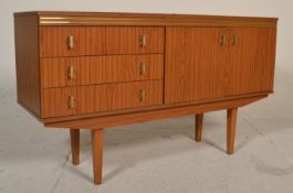 A retro mid 20th Century melamine sideboard credenza raised on tapering teak supports, having a bank