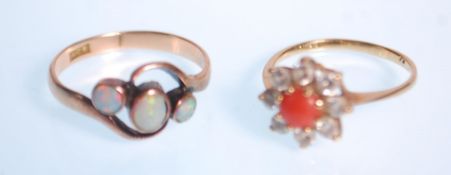 A 9ct gold hallmarked coral and diamond cluster ring. The central cabochon coral with halo of