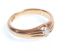 A stamped 18ct gold ring claw set with a central oval cut diamond. Diamond estimated at around