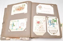 A vintage 20th Century postcard album containing a wide selection of postcards dating from the