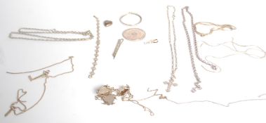A collection of silver jewellery to include a figaro chain necklace, a crucifix pendant, a heart