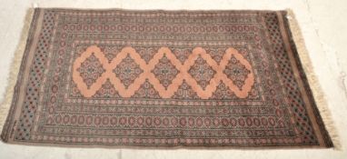 A vintage 20th Century Persian Islamic floor rug / carpet having multi coloured ground with