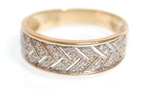 A hallmarked 14ct gold ring having pierced decoration plait design set with diamonds. Hallmarked