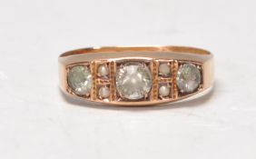 A Victorian hallmarked 15ct gold ladies ring set with a central round cut white stone flanked by