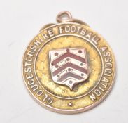 Local Interest - A hallmarked 9ct gold medal / fob for the Gloucestershire Football Association.