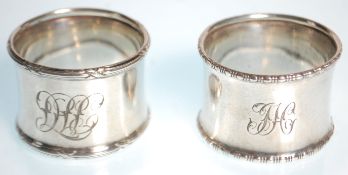 Two silver hallmarked napkin rings to include one with gadrooned borders and engraved initials to