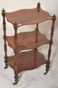 A 19th Century Victorian mahogany three tier whatnot etagere having serpentine shelves with turned