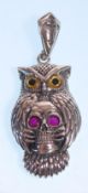 A stamped 925 silver necklace having a rope twist chain with an owl pendant having yellow and