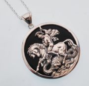 A sterling silver and onyx pendant necklace depict