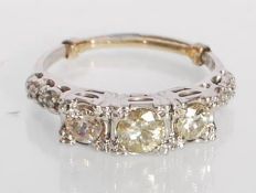 A stamped 14ct white gold three stone diamond ring