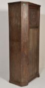 A 1920's carved oak hall cupboard wardrobe in the