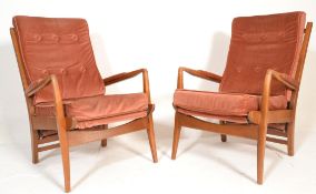 A pair of mid century teak wood Cintique armchairs