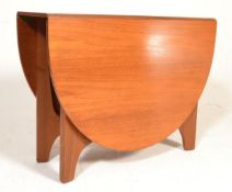 A 1970's retro teak wood drop leaf dining table be