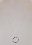 A 18ct white gold & diamond pendant of circular de