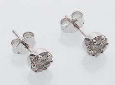 A pair of 18ct white gold stud earrings inset with