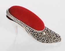 A sterling silver pin cushion in the form of a lad