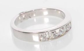A platinum eternity ring channel set with 4 round