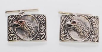 A pair of sterling silver cufflinks embossed with