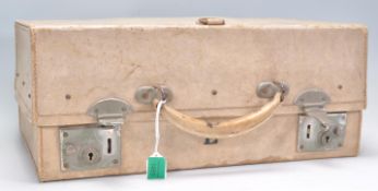 An early 20th Century white leather travel vanity